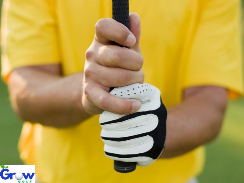 Golfer practising correct grip position at the driving range